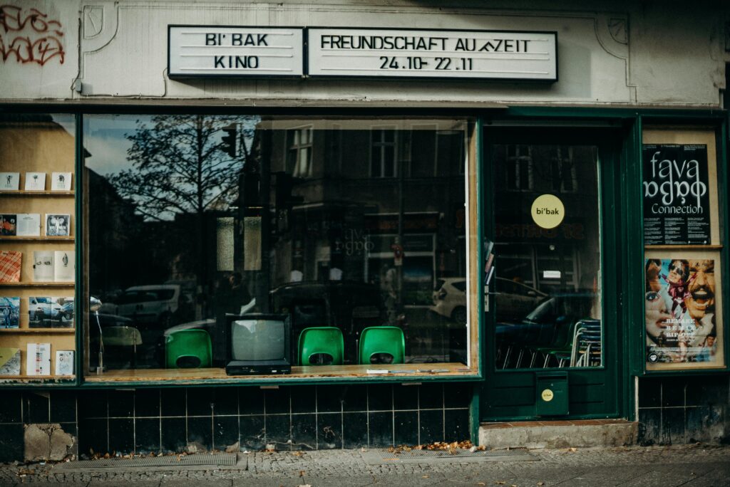 A vintage storefront displaying an old TV, books, and posters, reflecting a nostalgic urban atmosphere.